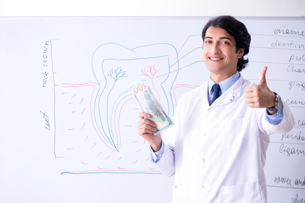 A male dental nurse holding money