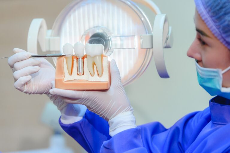 A trainee dental nurse holding a human teeth model.